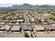 Picturesque aerial view capturing a desert home surrounded by a vibrant community, mountains, and blue skies at 3016 High Range Dr, Las Vegas, NV 89134