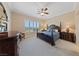 This bedroom features carpeted floors, a ceiling fan, and a window with natural light at 3016 High Range Dr, Las Vegas, NV 89134