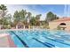 Large swimming pool with lap lanes surrounded by lush greenery and comfortable lounge chairs for relaxation at 3016 High Range Dr, Las Vegas, NV 89134