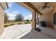 Relaxing covered patio with ceiling fan and views of a lush green golf course and blue sky at 3016 High Range Dr, Las Vegas, NV 89134