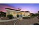 Charming single-story home at twilight with stone landscaping and a tile roof at 3016 High Range Dr, Las Vegas, NV 89134