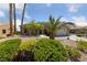 Well-manicured front yard showcasing lush desert landscaping, a palm tree, and a welcoming entryway at 3016 High Range Dr, Las Vegas, NV 89134