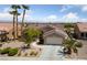 Charming single-story home with desert landscaping, mature palm trees, and a well-maintained front yard at 3016 High Range Dr, Las Vegas, NV 89134