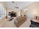 Spacious living room featuring plush carpet, neutral paint, and an entertainment center at 3016 High Range Dr, Las Vegas, NV 89134