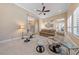 Bright living room with neutral tones, comfortable seating, and a ceiling fan at 3016 High Range Dr, Las Vegas, NV 89134