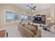 Bright living room with large windows, comfortable seating, and a media center at 3016 High Range Dr, Las Vegas, NV 89134