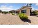 Charming backyard showcasing desert landscaping with lush shrubs and a view of neighboring homes at 3016 High Range Dr, Las Vegas, NV 89134