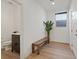 Modern bathroom with wood floors, a dark vanity, toilet, and a decorative plant at 3038 Villanelle Ave, Henderson, NV 89044