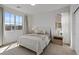 Inviting bedroom with plush carpeting, natural light from the large windows, and stylish neutral decor at 3038 Villanelle Ave, Henderson, NV 89044