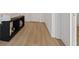 Bright hallway featuring stylish light wood floors, white walls, and a modern console table at 3038 Villanelle Ave, Henderson, NV 89044