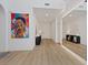 Bright hallway featuring stylish light wood floors, white walls, and a decorative mirror at 3038 Villanelle Ave, Henderson, NV 89044