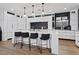 Contemporary kitchen showcasing a large quartz island and sleek black backsplash at 3038 Villanelle Ave, Henderson, NV 89044
