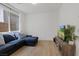 Comfortable living room with a plush blue sofa and a media console at 3038 Villanelle Ave, Henderson, NV 89044