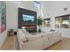 Bright living room featuring a modern fireplace, large windows, and comfortable seating area at 3038 Villanelle Ave, Henderson, NV 89044