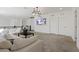 A comfortable carpeted living room with neutral tones, modern lighting, and access to other areas of the home at 3038 Villanelle Ave, Henderson, NV 89044