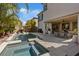 Backyard oasis features a large pool, hot tub, patio, and an outdoor dining area at 3038 Villanelle Ave, Henderson, NV 89044
