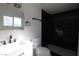 This bathroom features black marble shower and modern fixtures at 3115 Wright Ave, North Las Vegas, NV 89030