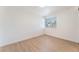 Bright bedroom featuring a large window and clean, neutral finishes, and light wood flooring at 3320 Osage Ave, Las Vegas, NV 89101