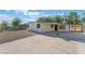 Single-story home showing long driveway, covered parking, metal security bars and fencing at 3320 Osage Ave, Las Vegas, NV 89101
