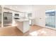 Bright kitchen featuring white cabinets, stainless steel appliances, an island, and a window for ample natural light at 3320 Osage Ave, Las Vegas, NV 89101