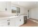 Bright kitchen featuring white cabinets, stainless steel appliances, quartz countertops, and sleek black hardware at 3320 Osage Ave, Las Vegas, NV 89101