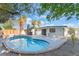 Backyard features a kidney-shaped pool, desert landscaping, a concrete patio, and a privacy fence at 3320 Osage Ave, Las Vegas, NV 89101