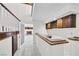 Elegant bar area adjacent to the staircase with rich wood accents and a view into the living room at 3382 Montessouri, Las Vegas, NV 89117