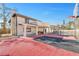 A stunning red basketball court with a covered porch and columns in the backyard at 3382 Montessouri, Las Vegas, NV 89117