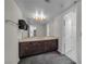 Bathroom featuring dark wood cabinets, large mirror, and neutral carpet at 3382 Montessouri, Las Vegas, NV 89117