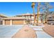 Charming home featuring a three-car garage and a landscaped yard with mature trees and a stone walkway at 3382 Montessouri, Las Vegas, NV 89117
