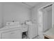 All-white laundry area with a washer, dryer and utility sink near the doorway at 3382 Montessouri, Las Vegas, NV 89117