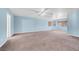 Expansive living room with carpet flooring, ample windows, and ceiling fan at 3382 Montessouri, Las Vegas, NV 89117