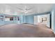 Spacious living room featuring large windows, carpet flooring, and open doorway at 3382 Montessouri, Las Vegas, NV 89117