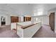 Open loft area with built-in bookshelves, neutral carpet, and natural light at 3382 Montessouri, Las Vegas, NV 89117