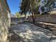 Backyard area with concrete patio offers outdoor living space and mature tree at 3429 Back Country Dr, North Las Vegas, NV 89031