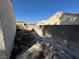 The backyard is empty and has a wall that separates it from the houses nearby at 3429 Back Country Dr, North Las Vegas, NV 89031