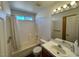 Bright bathroom with a shower-tub combo, a window, and a tiled vanity at 3429 Back Country Dr, North Las Vegas, NV 89031