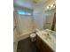 Bathroom features tub with shower and vanity with bright window light at 3429 Back Country Dr, North Las Vegas, NV 89031