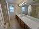 Bright bathroom with double sinks, tile countertops, and large mirror at 3429 Back Country Dr, North Las Vegas, NV 89031