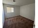 This carpeted bedroom has a window for natural light and neutral colored walls at 3429 Back Country Dr, North Las Vegas, NV 89031