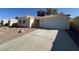 Charming single-story home with a well-maintained front yard, two-car garage, and spacious driveway at 3429 Back Country Dr, North Las Vegas, NV 89031