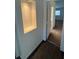 Bright hallway showcasing decorative recessed niche and view into adjoining carpeted room at 3429 Back Country Dr, North Las Vegas, NV 89031