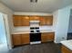 Bright kitchen featuring wood cabinetry, white tile countertops and backsplash, and gas range at 3429 Back Country Dr, North Las Vegas, NV 89031