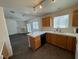 Open concept kitchen with wood cabinets, tile countertops, and stainless steel appliances at 3429 Back Country Dr, North Las Vegas, NV 89031