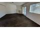 Spacious living room with wood-look flooring, bright windows, and a fireplace at 3429 Back Country Dr, North Las Vegas, NV 89031