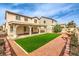 Spacious backyard featuring manicured lawn, fountain, patio, and two-story home at 3731 Prairie Orchid Ave, North Las Vegas, NV 89081
