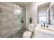 Modern bathroom featuring tiled shower with glass door, sleek vanity, and neutral color palette at 3731 Prairie Orchid Ave, North Las Vegas, NV 89081