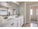 Modern bathroom with double sinks, white cabinets, and a window overlooking the neighborhood at 3731 Prairie Orchid Ave, North Las Vegas, NV 89081
