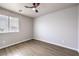 Bedroom with wood-look flooring, a ceiling fan, and a window with blinds at 3731 Prairie Orchid Ave, North Las Vegas, NV 89081