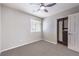 Neutral bedroom with a ceiling fan, window with blinds, closet, and gray carpet flooring at 3731 Prairie Orchid Ave, North Las Vegas, NV 89081